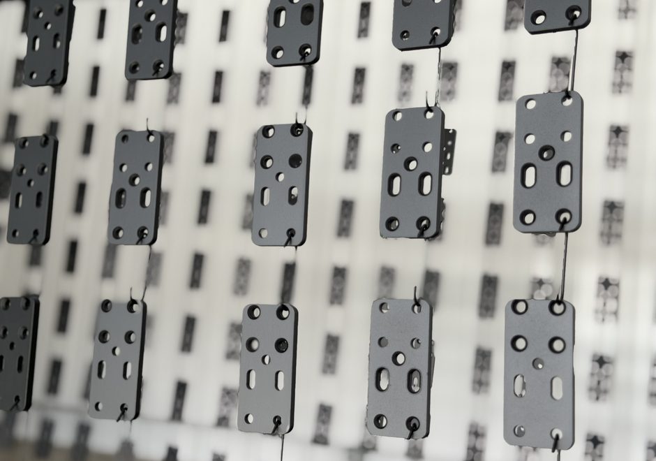 Close-up of powder coated steel brackets in matte gray